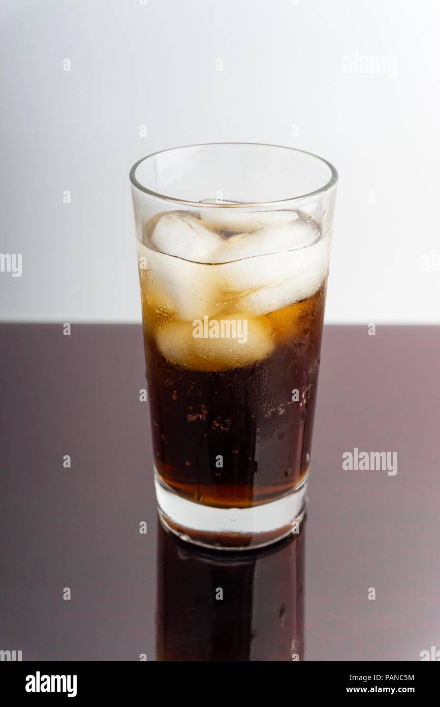 Cola in glass with ice cubes on white background Stock Photo - Alamy