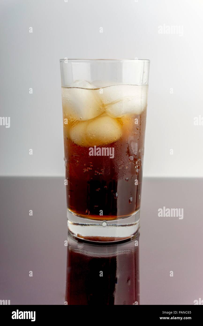 Cola in glass with ice cubes on white background Stock Photo - Alamy