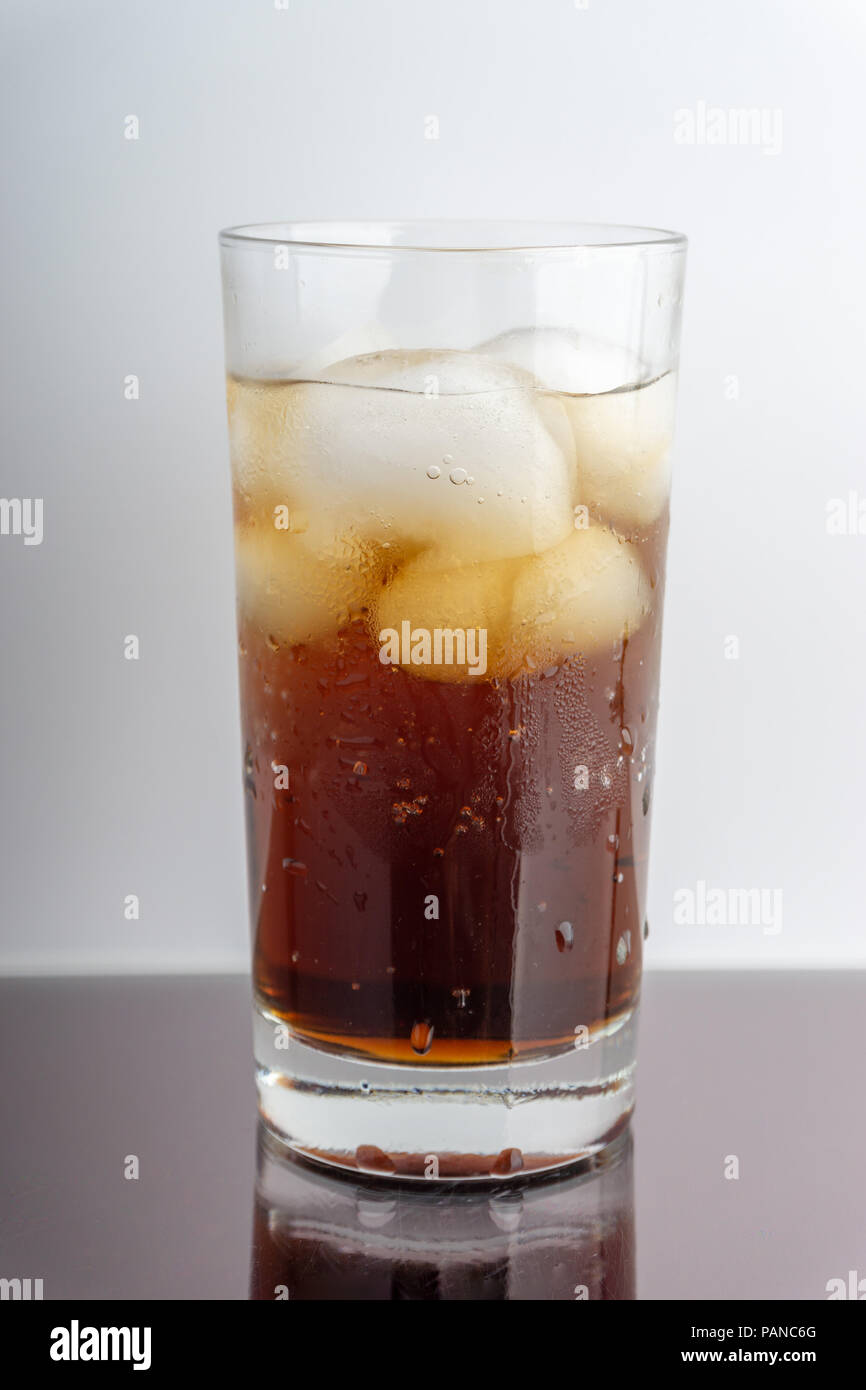 Cola in glass with ice cubes on white background Stock Photo - Alamy