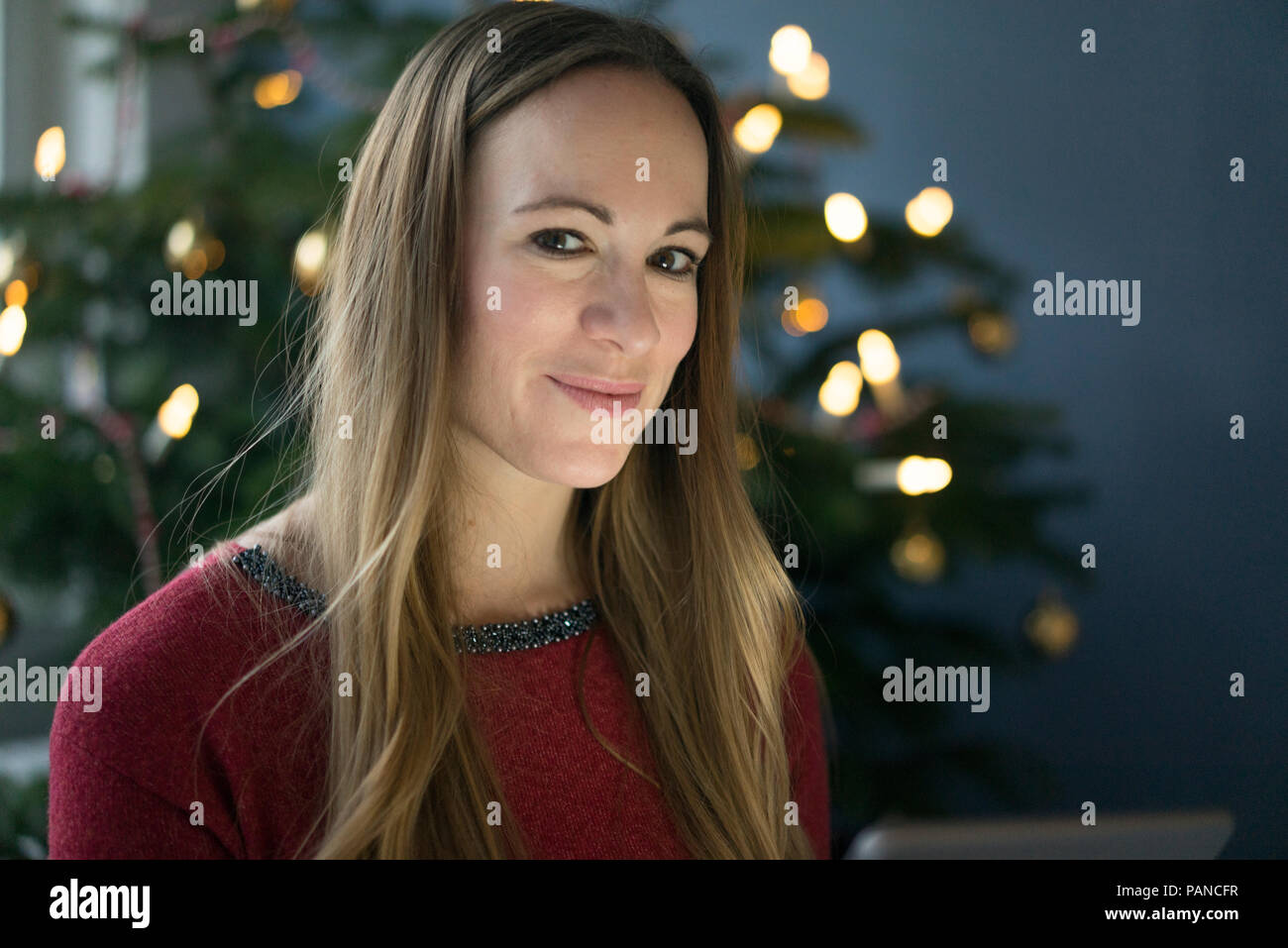 Portrait of smiling woman at Christmas time Stock Photo