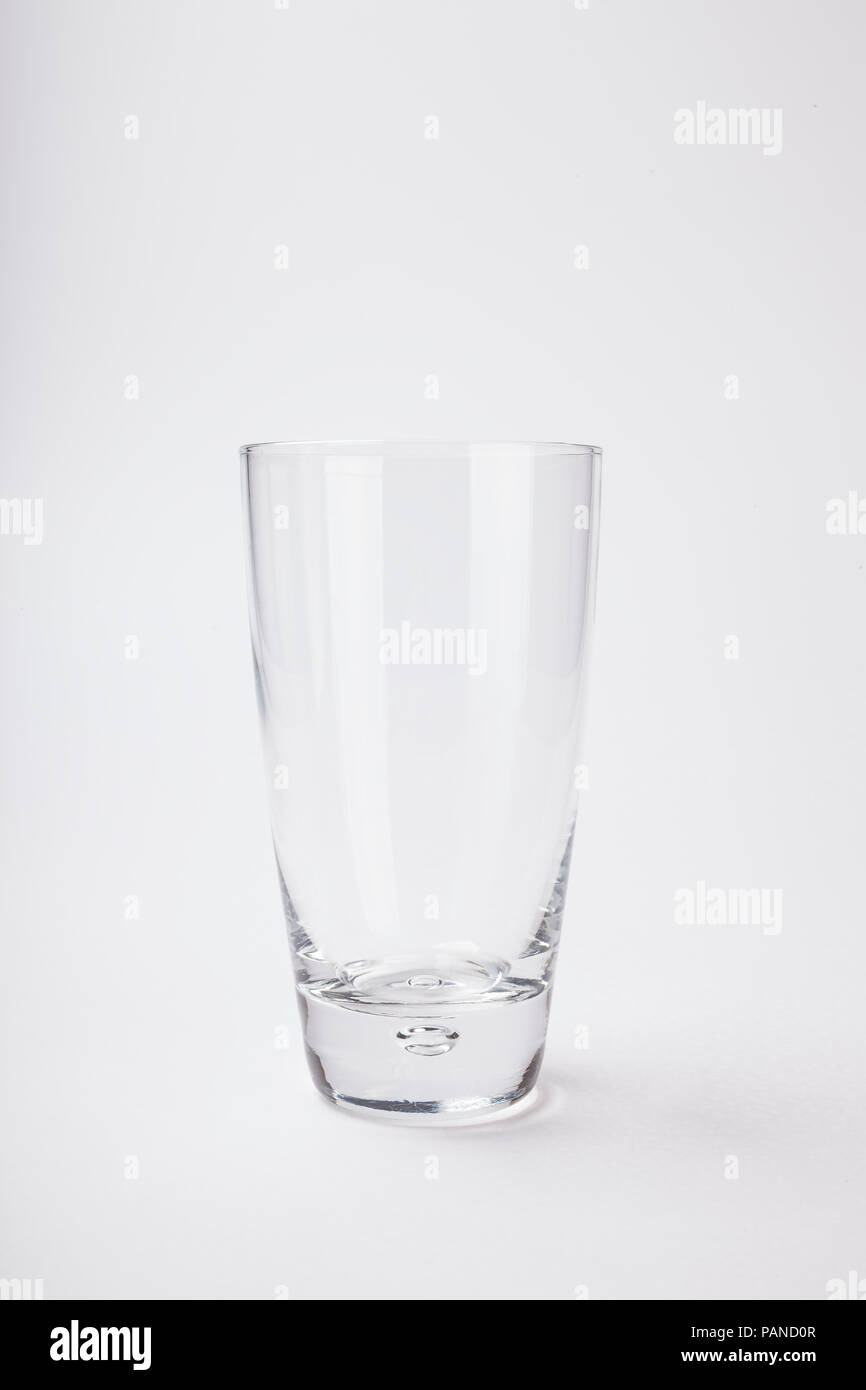Tall empty glass isolated on white Stock Photo