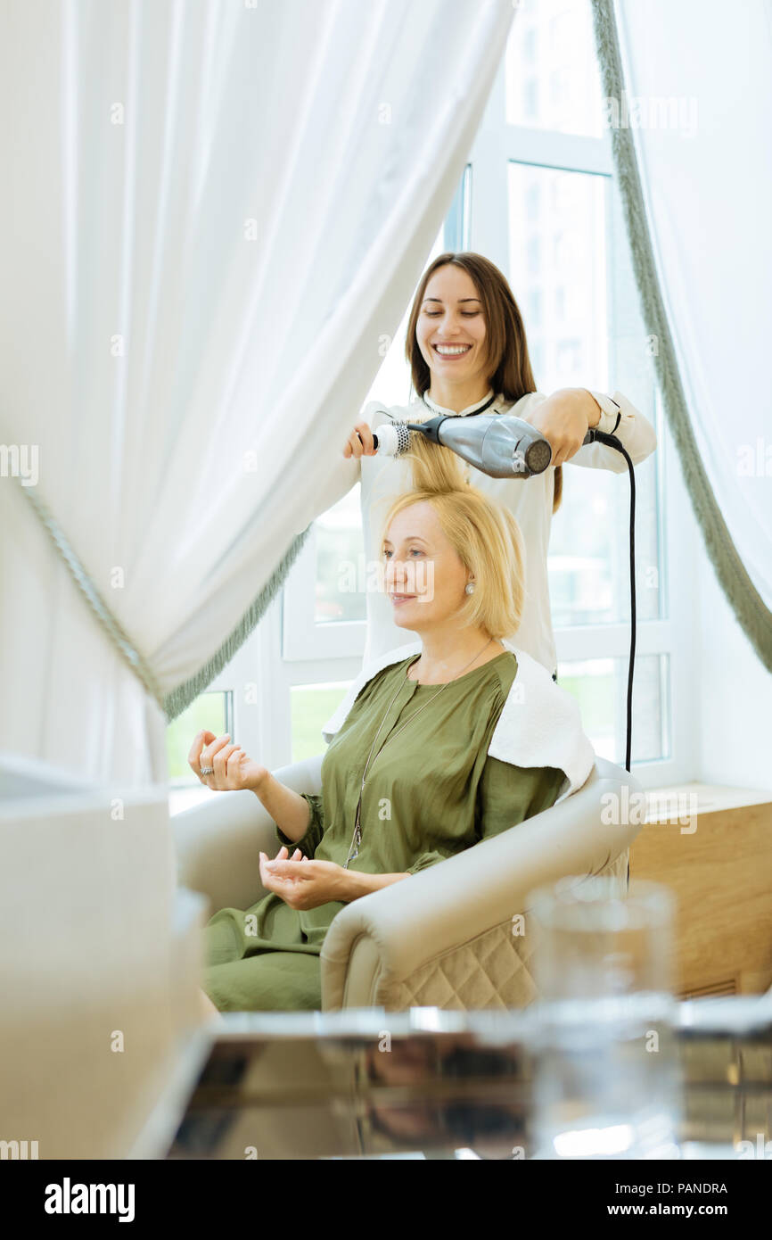 Professional Hair Stylist Drying Her Clients Hair Stock Photo