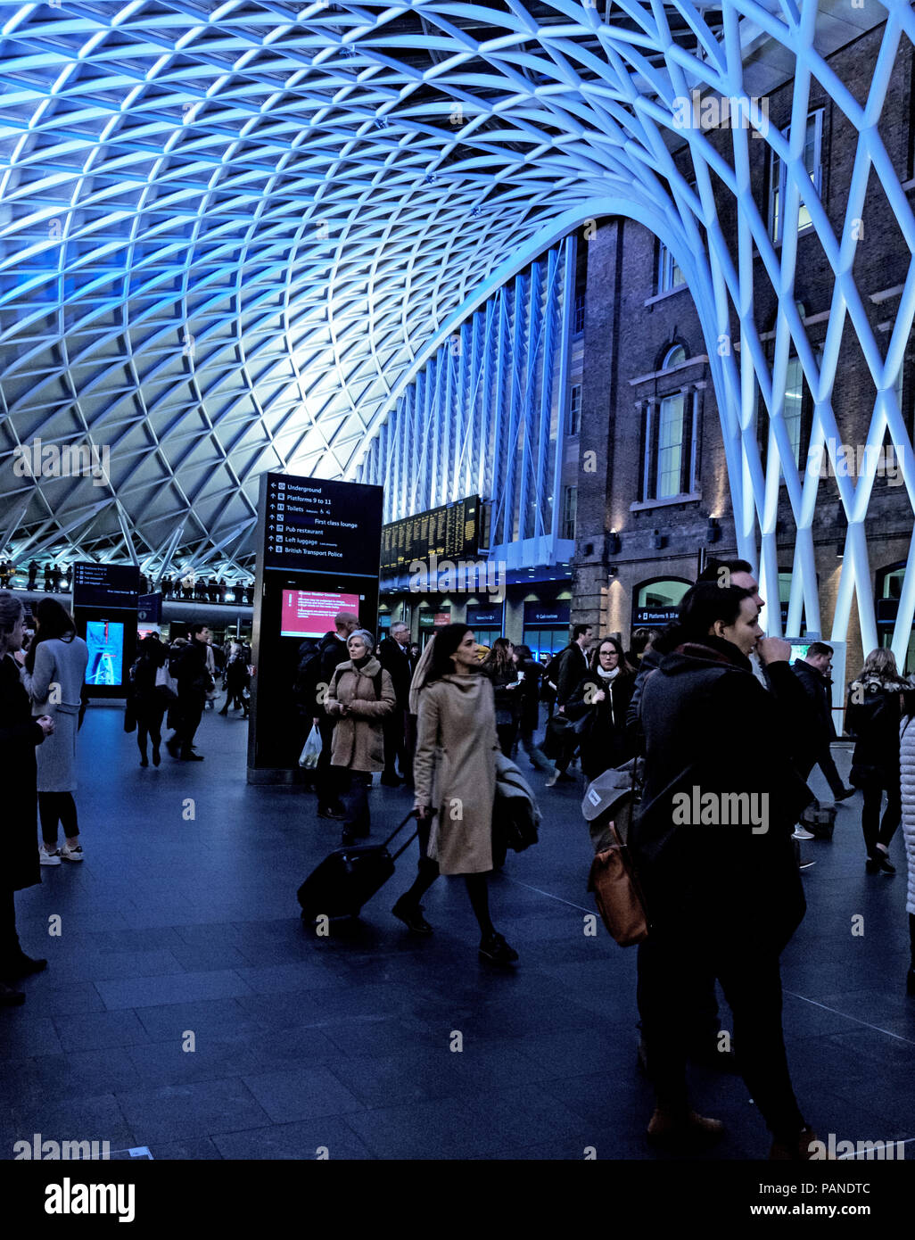 People wait for trains and walk in the Kings Cross Concourse, under the ...