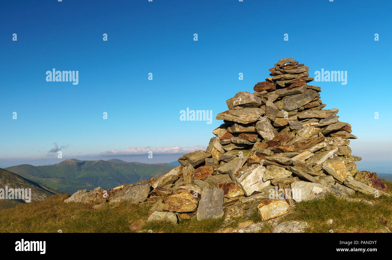 A pile of rocks arranged to mark the top of a mountain Stock Photo - Alamy