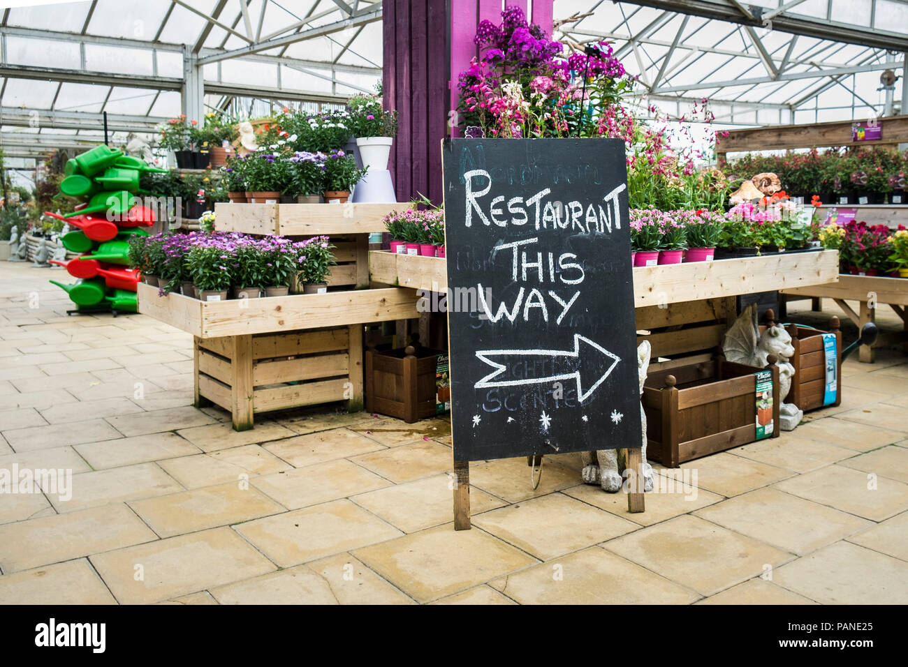 A sign giving direction to a restaurant in a garden centre. Stock Photo