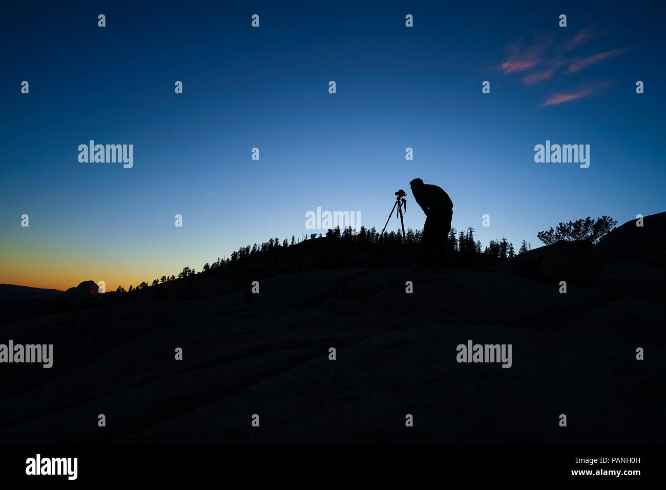 Landscape Photographer silhouette - taking pictures of Half Dome from Olmsted Point at sunrise - Yosemite National Park Stock Photo