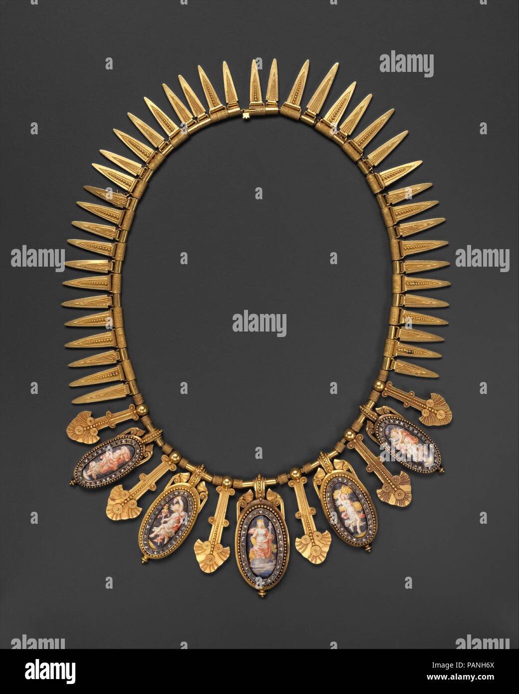 Necklace. Artist: Eugêne Fontenay (French, 1823-1887). Culture: French, Paris. Dimensions: L. 16-3/8 in. (41.6 cm.). Date: ca. 1870.  This gold chain has five oval enameled pendants depicting personifications of Europe and the Seasons. Each oval is framed in diamonds interspersed with long stylized palmette-shaped pendants, and forty-one leaf-shaped pendants, decorated with granulation and wirework suspended from alternately plain and coiled tubular links.  The use of granulation and images of classical maidens, as well as the overall organization, demonstrate the designer's dependence upon an Stock Photo