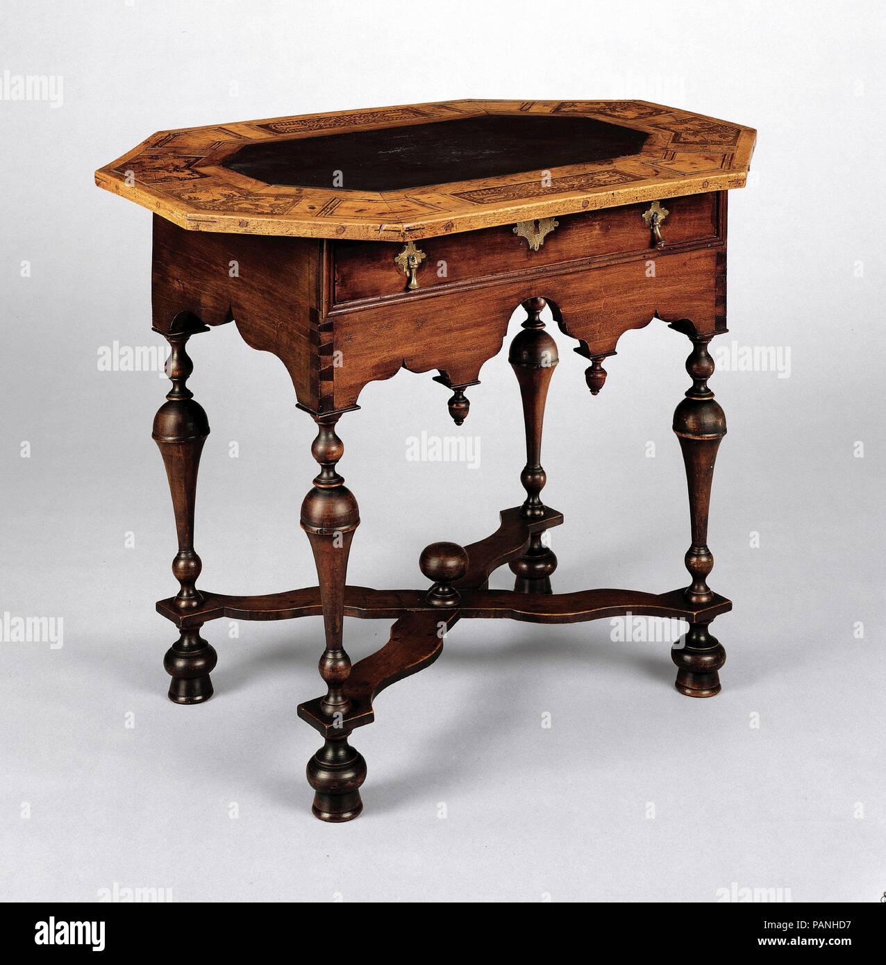 Slate Table. Culture: American. Dimensions: 28 1/2 x 35 1/8 x 25 in. (72.4 x 89.2 x 63.5 cm). Date: 1715-35. This table is distinguished for combining an imported Swiss top with an American- made base. The octagonal top's slate center is framed by a marquetry border with heraldic motifs in a style characteristic of workshops in eastern Switzerland. The piece may have been used as either a dressing table or a serving table. Museum: Metropolitan Museum of Art, New York, USA. Stock Photo