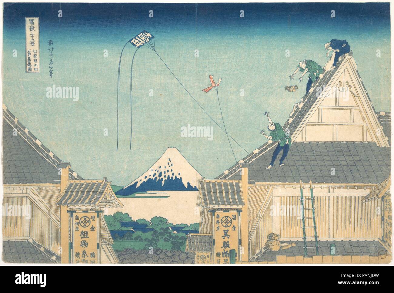Mitsui Shop at Surugacho in Edo (Edo Surugacho Mitsui mise ryaku zu), from the series Thirty-six Views of Mount Fuji (Fugaku sanjurokkei). Artist: Katsushika Hokusai (Japanese, Tokyo (Edo) 1760-1849 Tokyo (Edo)). Culture: Japan. Dimensions: Oban 10 x 15 in. (25.4 x 38.1 cm). Date: ca. 1830-32.  The celebrated kimono shop of the Mitsui family, Echigoya, was located on Edo's busiest street, Surugacho. Mount Fuji is glimpsed from a high vantage point above the street between Echigoya's two buildings. The triangular profile of the roof is echoed in the shape of the mountain. Museum: Metropolitan M Stock Photo