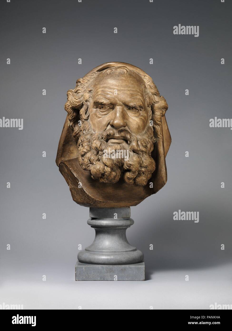 Head of a Bearded Elder. Artist: Augustin Pajou (French, Paris 1730-1809 Paris). Culture: French, probably Paris. Dimensions: Overall, without socle (confirmed): 14 1/4 x 12 1/8 x 9 1/2 in. (36.2 x 30.8 x 24.1 cm);  Height with socle: 21 1/2 in. (54.6 cm). Date: 1768.  The precise meaning of this bristling elder remains to be determined. Suggestions for his identity have ranged from Aristotle to Moses to a retired pugilist. The work fits within the French academic tradition of modeling heads to express various passions, but which could this belligerent character personify? Barely controlled ra Stock Photo