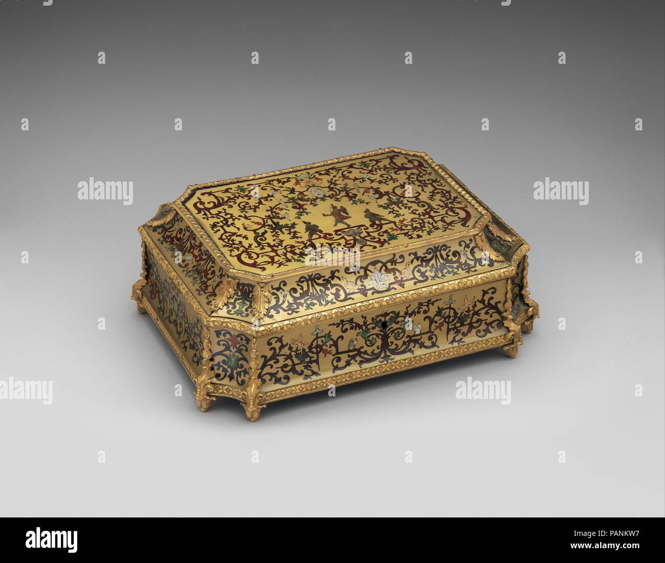 Toilet casket. Culture: French. Dimensions: Overall (confirmed): 5 x 13 1/4 x 10 in. (12.7 x 33.7 x 25.4 cm). Date: 1700-1715.  Known in French as a carré de toilette, this rectangular casket has canted corners and is richly decorated in so-called boulle marquetry of brass inlaid with tortoiseshell, mother-of-pearl, and tinted horn (contre partie). Containing ribbons, feathers, or other adornments, boxes like this played a role in the elaborate dressing ritual of the past and would have been placed on the dressing table. Similar caskets are depicted in Jean-Marc Nattier's portrait Madame Marso Stock Photo