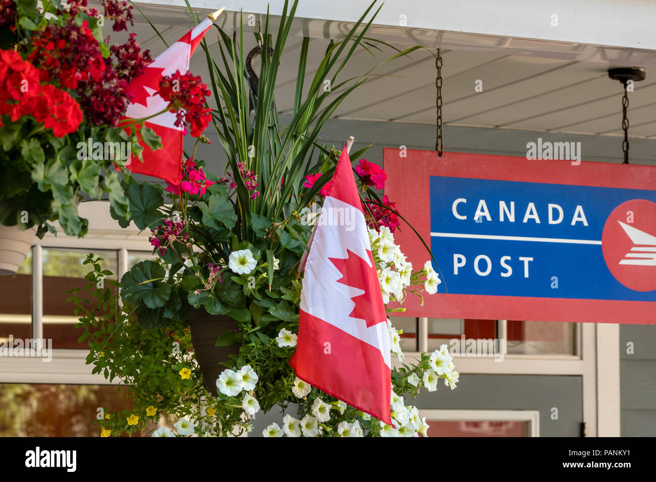 Closeup of building with flowers and Canadian flags Stock Photo Alamy