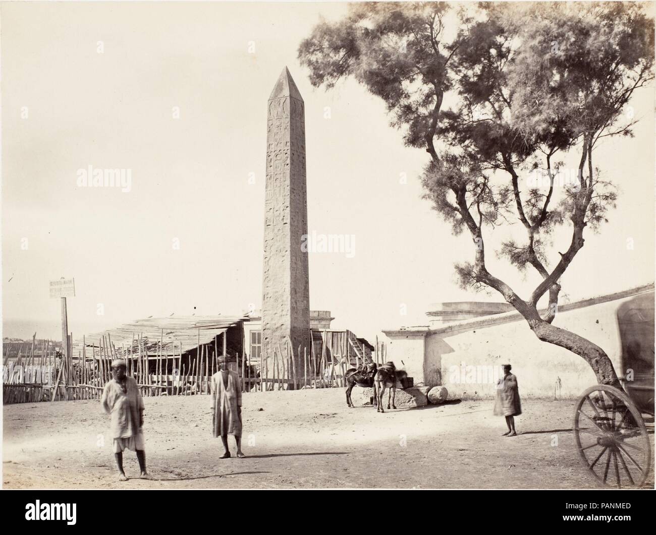 [Egyptian Obelisk, 'Cleopatra's Needle,' in Alexandria, Egypt]. Artist: Attributed to Francis Frith (British, Chesterfield, Derbyshire 1822-1898 Cannes, France). Dimensions: Image: 15.5 x 20.8 cm (6 1/8 x 8 3/16 in.). Date: ca. 1870.  Here the Central Park obelisk sits in its late nineteenth-century environment, a neglected area of the Alexandria harbor. What this photograph did not capture was the new buildings going up nearby, indicating the harbor was undergoing modernization. It was this development that created an atmosphere in which Egyptian nationalists in 1880 argued that the obelisk s Stock Photo