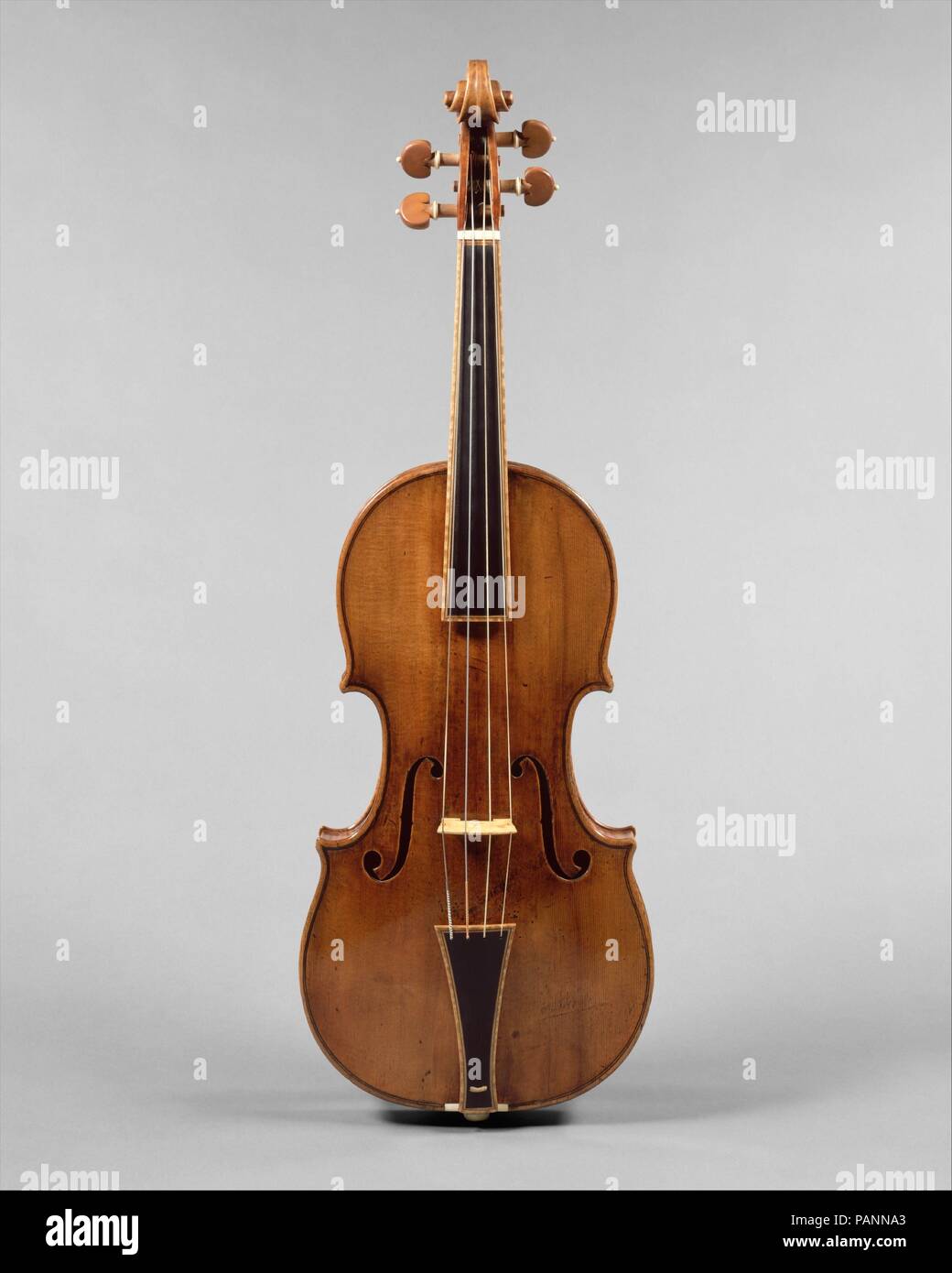 'The Gould' Violin. Culture: Italian (Cremona). Dimensions: Height: 23 1/4 in. (59 cm)  Width: 7 3/4 in. (19.7 cm). Maker: Antonio Stradivari (Italian, Cremona 1644-1737 Cremona). Date: 1693.  'The Gould' violin has a two-piece maple back with a tight flame and a two-piece spruce top with an orange-brown varnish. Although modern performers continue to use seventeenth- and eighteenth-century stringed instruments by great makers, nearly all of the instruments have been modified in order to remain useful as performance spaces grew larger and repertoire pushed instruments to create louder sound ov Stock Photo