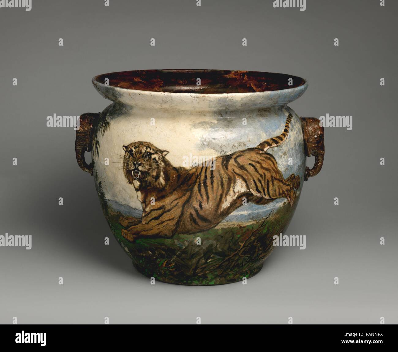 Pot. Culture: French, Longwy. Decorator: Martinus Kuijtenbrouwer (Dutch, 1821-1897). Dimensions: Overall (confirmed, irregular diameter at rim): 18 × 23 1/2 × 20 in. (45.7 × 59.7 × 50.8 cm). Manufactory: Probably Longwy manufactory. Date: 1882.  Determined that pottery vessels should be regarded as true works of art, avant-garde ceramicists in France in the last decades of the nineteenth century transformed their craft into an intellectual and emotional endeavor. The pioneers of this revival were Jean Carriès, Ernest Chaplet, Théodore Deck, and Auguste Delaherche. These revolutionary artist-po Stock Photo