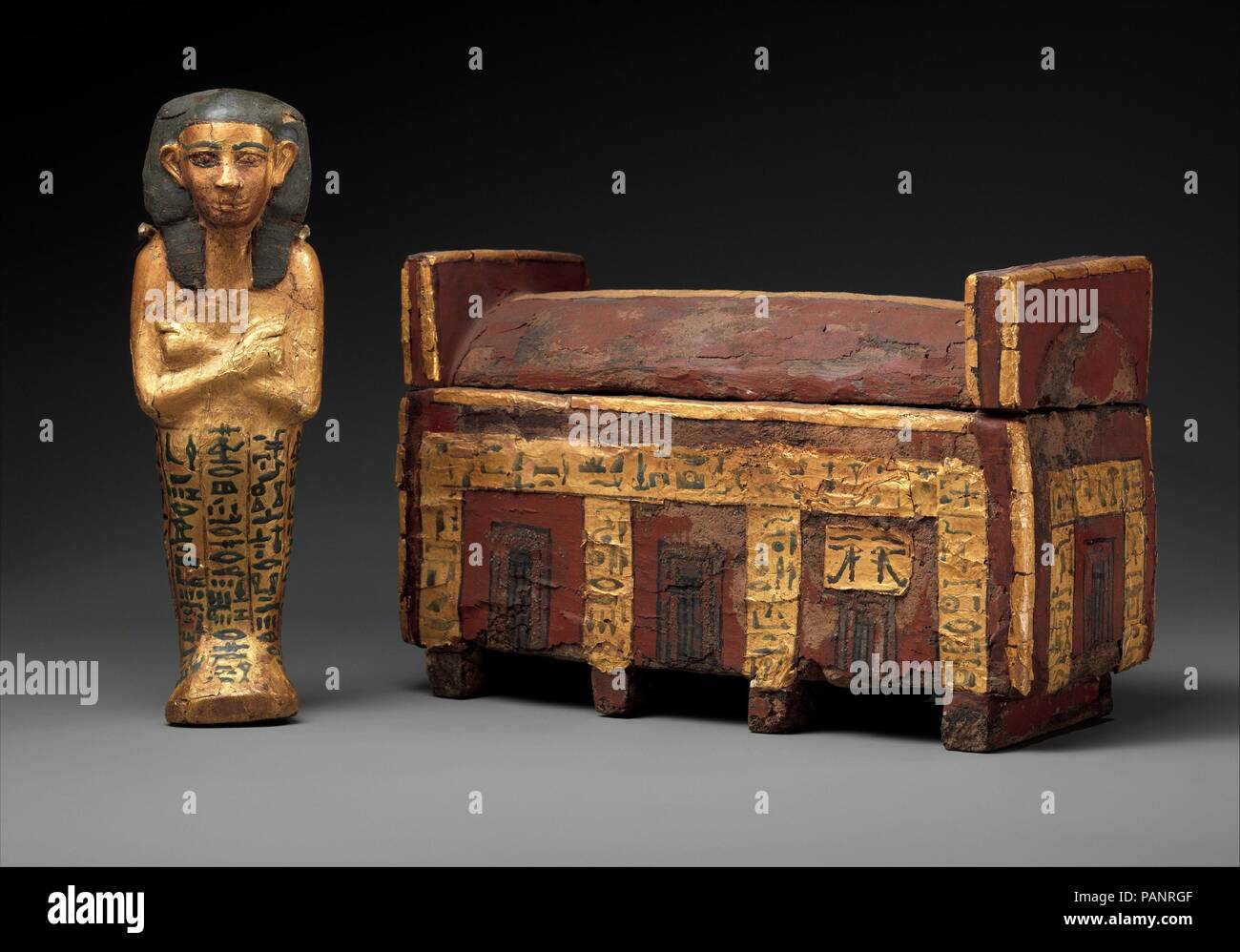 Shabti and Coffin of the King's Son Wahneferhotep. Dimensions: 14.3.69a, b: L. 25.1 cm (9 7/8 in.)  W. 10.4 cm (4 1/8 in.)  H. 15.5 cm (6 1/8 in.); 14.3.70: H. 21 cm (8 1/4 in.); W. 6.8 cm (2 11/16 in.); D. 5.2 cm (2 1/16 in.). Dynasty: Dynasty 12-13. Date: ca. 1981-1640 B.C..  The miniature coffin is inscribed with funerary spells as if it were an actual Middle Kingdom coffin. Inside was the shabti wearing a modified nemes, a type of head covering worn by the king. The standard spell on the shabti enabled the owner to avoid the burden of labor in the afterlife. These objects were usually plac Stock Photo