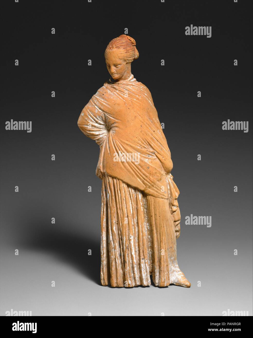 Terracotta statuette of a standing woman. Culture: Greek, probably  Boeotian. Dimensions: H. 6 7/16 in. (16.4 cm). Date: late 4th-early 3rd  century B.C.. Although the Greeks had been making terracotta statuettes  since