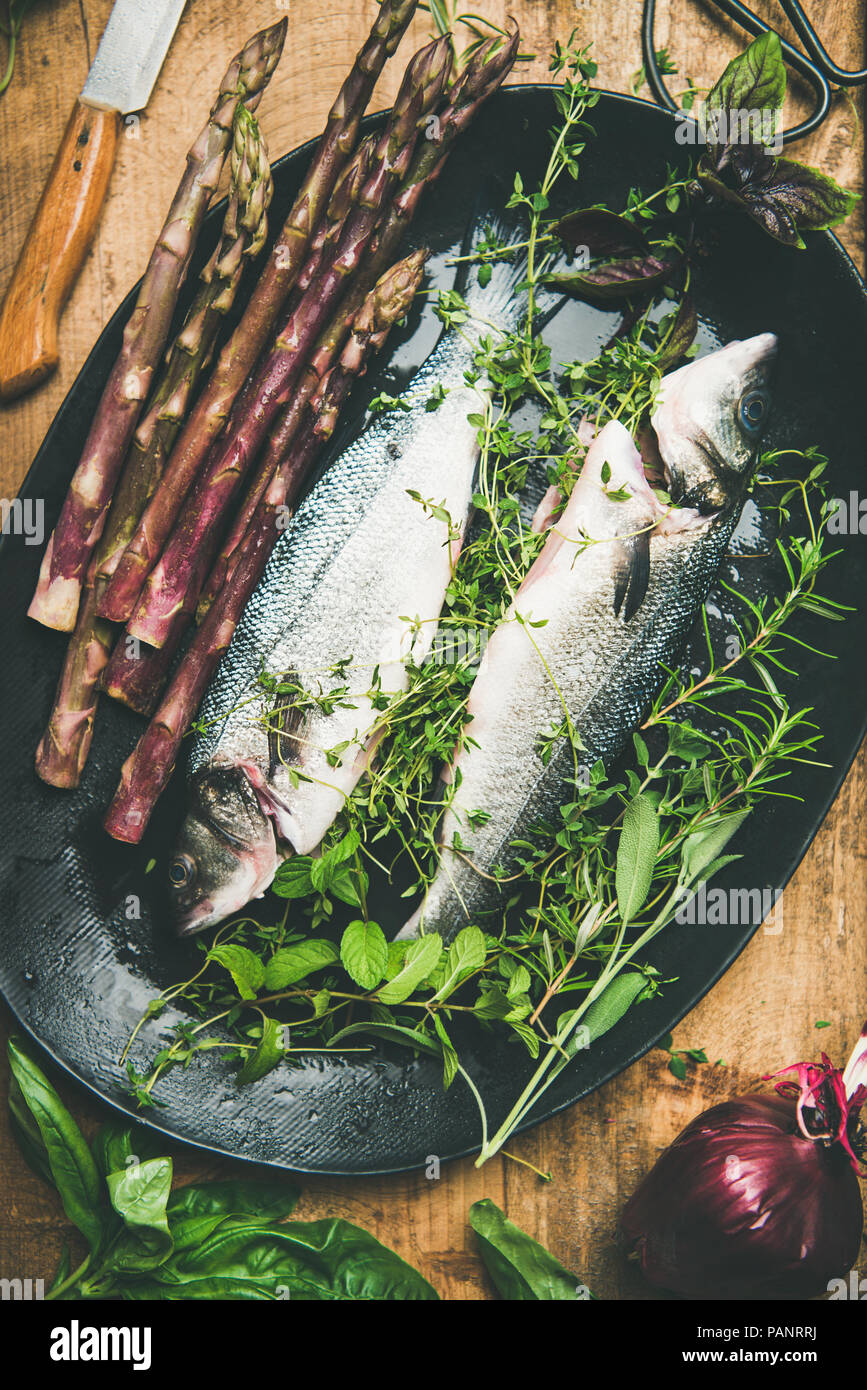 Raw uncooked sea bass fish with herbs and vegetables Stock Photo Alamy