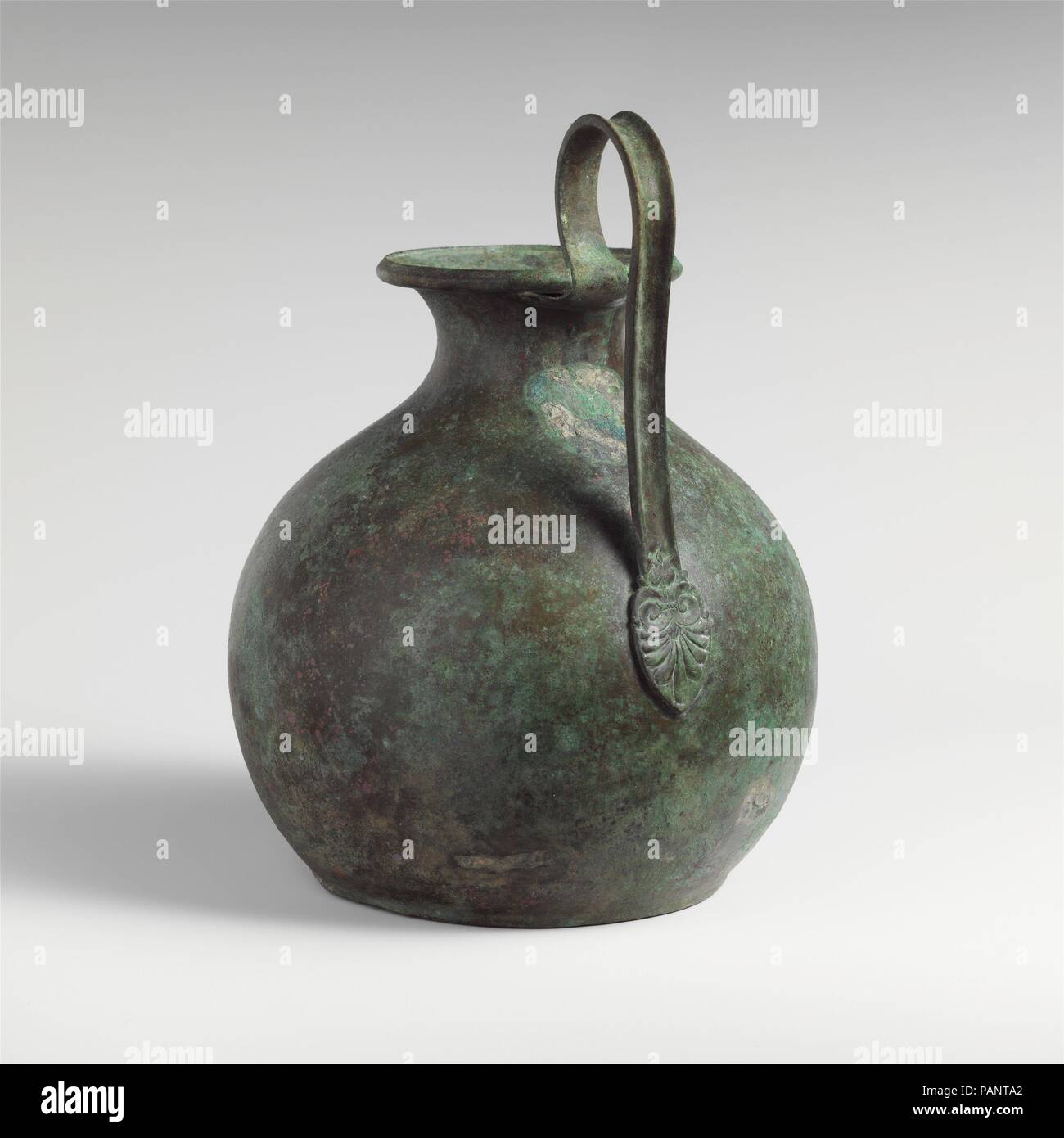 Bronze oinochoe (jug). Culture: East Greek. Dimensions: H. x width  9 1/16 x 5 in. (23 x 12.7 cm)  diameter  7 in. (17.8 cm). Date: late 6th century B.C..  Handle is worked separately; it may be an ancient replacement. Museum: Metropolitan Museum of Art, New York, USA. Stock Photo