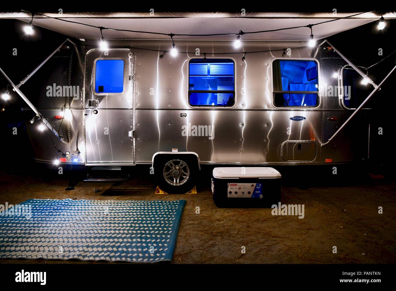 Airstream Sport travel trailer at night with the lights on Stock Photo Alamy