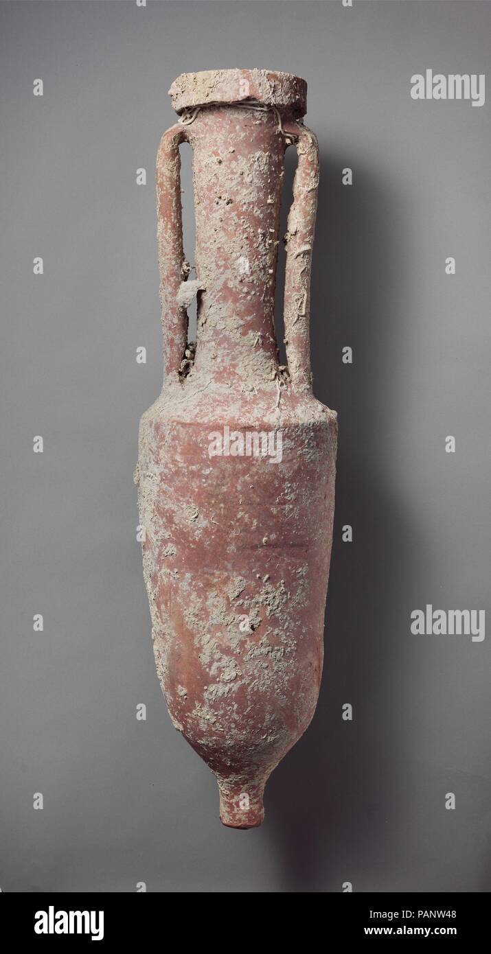 Terracotta wine amphora. Culture: Roman. Dimensions: H. 40 1/2 in. (102.9 cm). Date: ca. 100 B.C..  The amphora comes from a shipwrecked cargo vessel (Grand Congloué B) that was explored by Capt. Cousteau and Prof. Benoît in 1952-3. The ship's hold contained some 1,200-1,500 Roman wine amphorae made at or near Cosa in Etruria. The cargo was evidently destined for markets in Gaul, where Celtic chieftains had developed a taste for wine and tableware supplied by Roman merchants. Museum: Metropolitan Museum of Art, New York, USA. Stock Photo