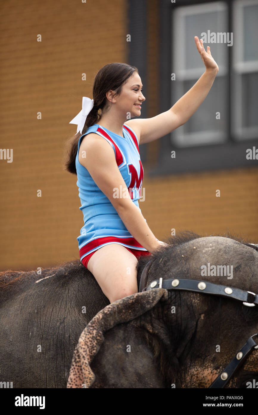 Peru, Indiana, USA July 21, 2018 Young women riding elephants down