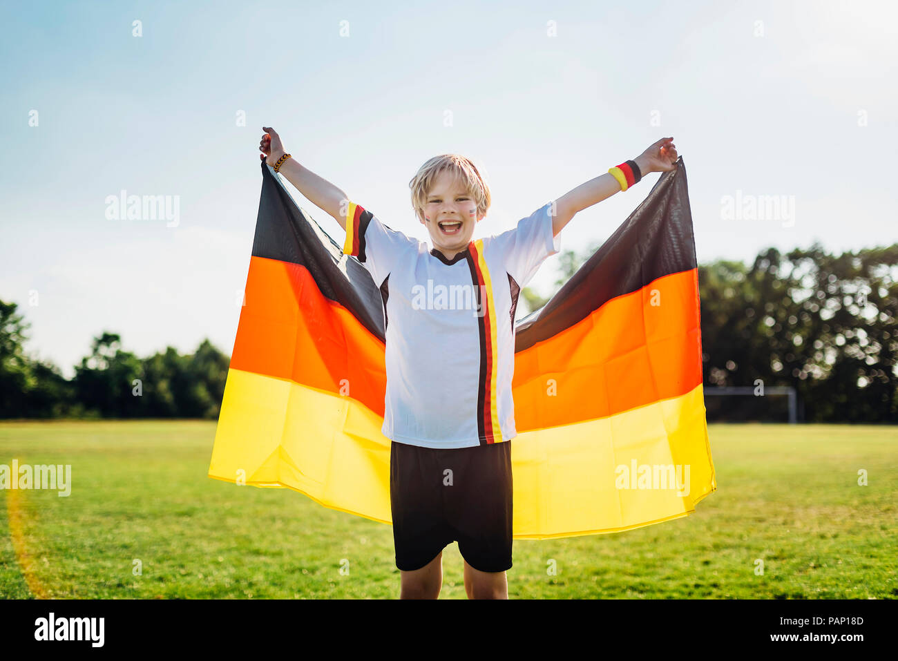 Boy, enthusiastic for soccer world championship, waving German flag Stock Photo