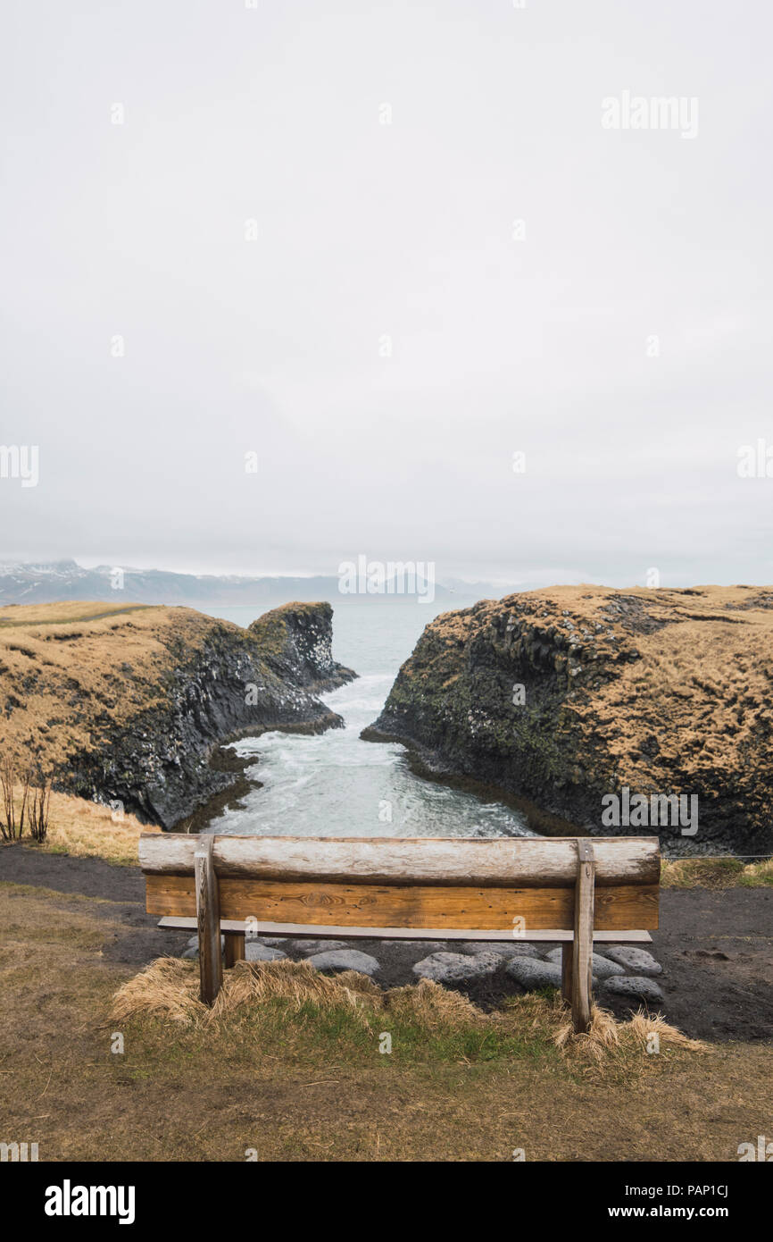 Iceland, empty bench with view to coast Stock Photo