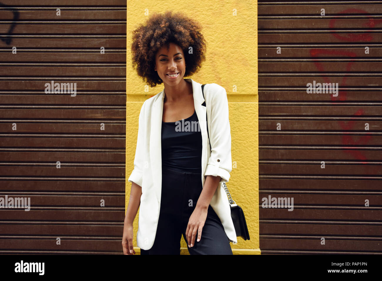 Portrait of fashionable young woman with curly hair Stock Photo