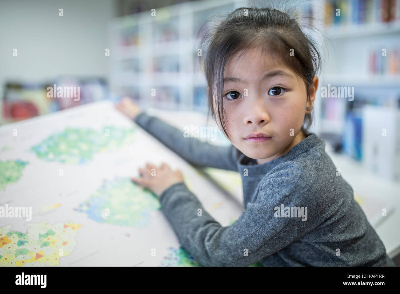 Portrait of schoolgirl with book in school Stock Photo - Alamy