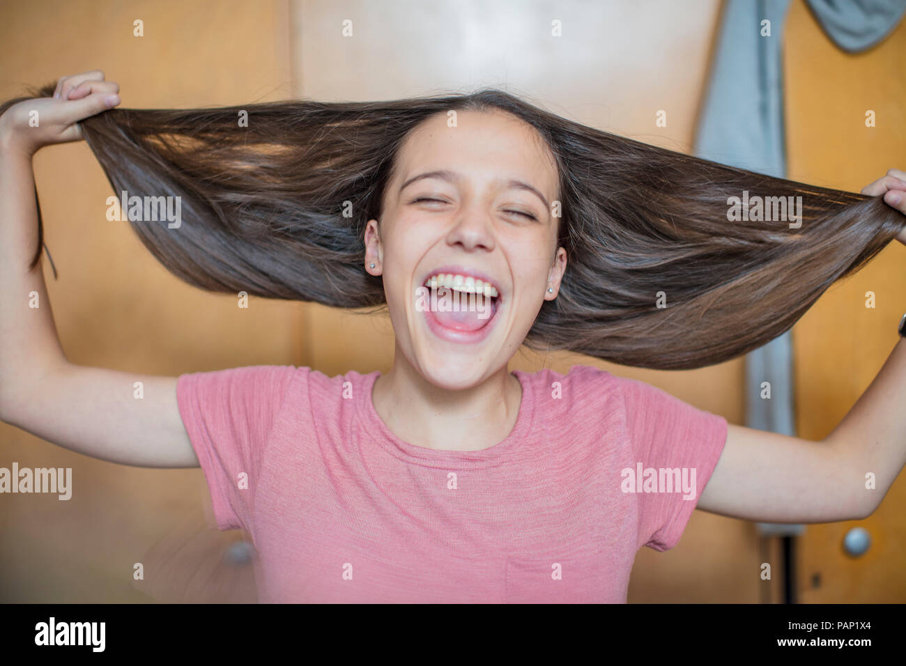 Portrait of carefree teenage girl playing with her hair Stock Photo