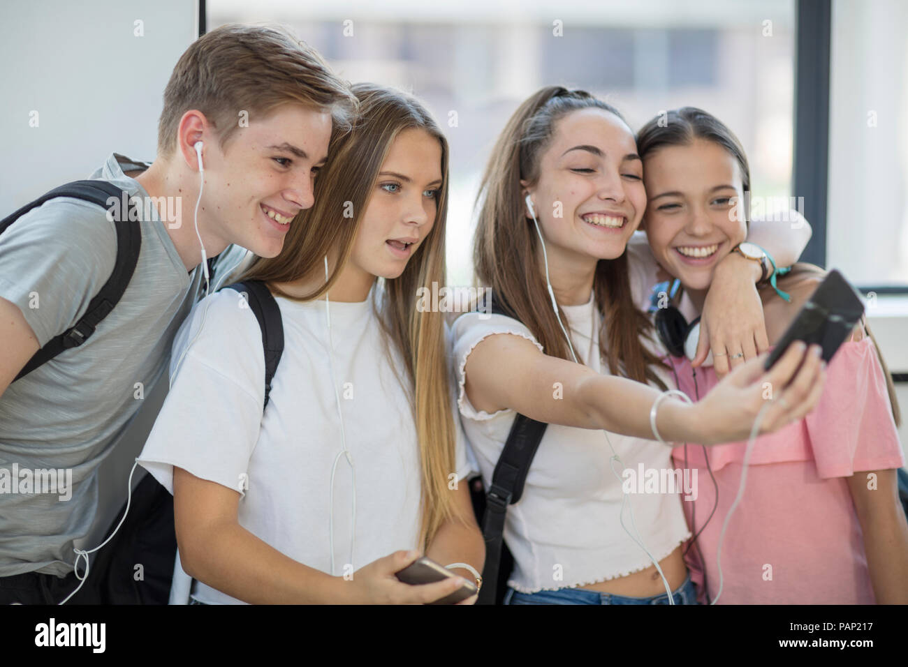 Happy students taking a selfie in school Stock Photo