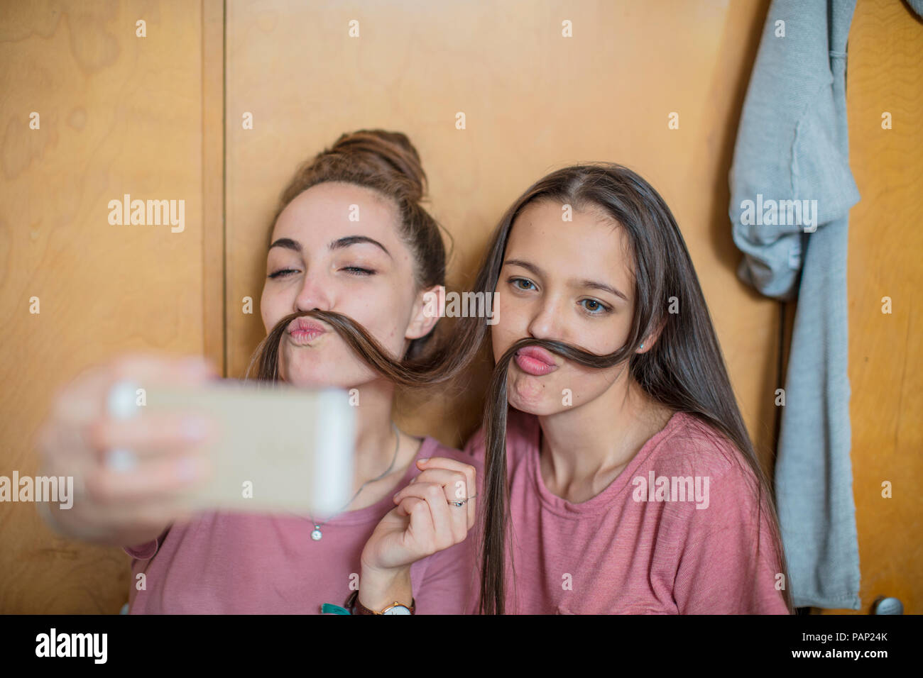 Playful happy teenage girls taking a selfie Stock Photo