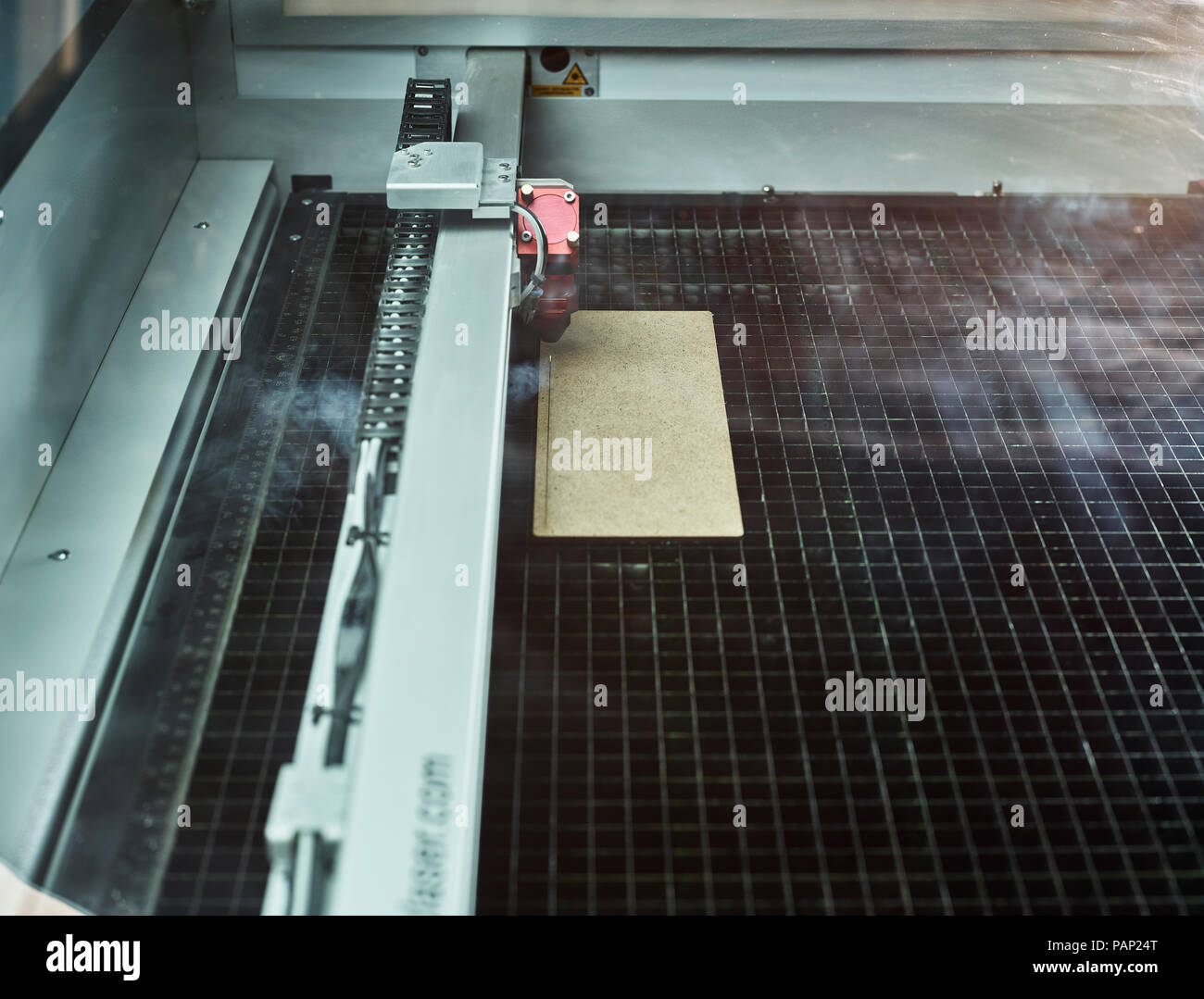 Laser cutter cutting wooden chipboard Stock Photo