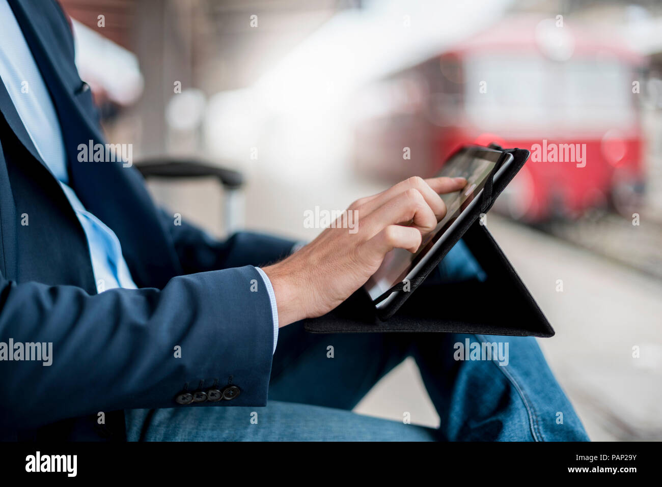 Close-up of businessman at the station using tablet Stock Photo