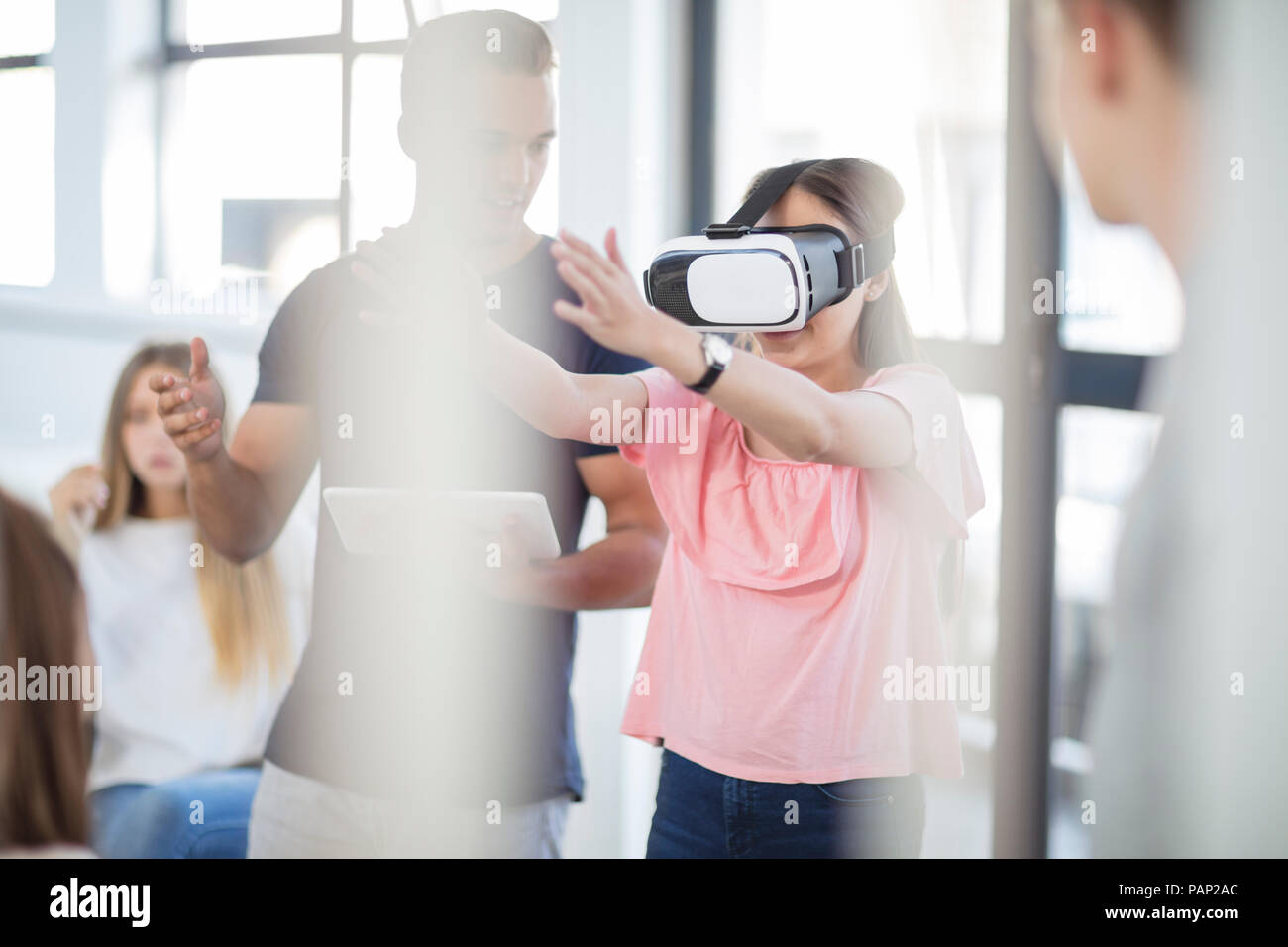 Teacher with tablet student wearing VR glasses in class Stock Photo