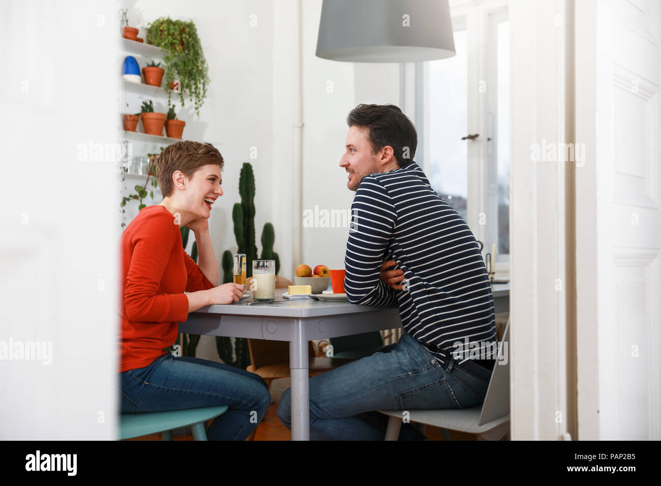 Couple sitting in kichen, talking, having breakfast Stock Photo