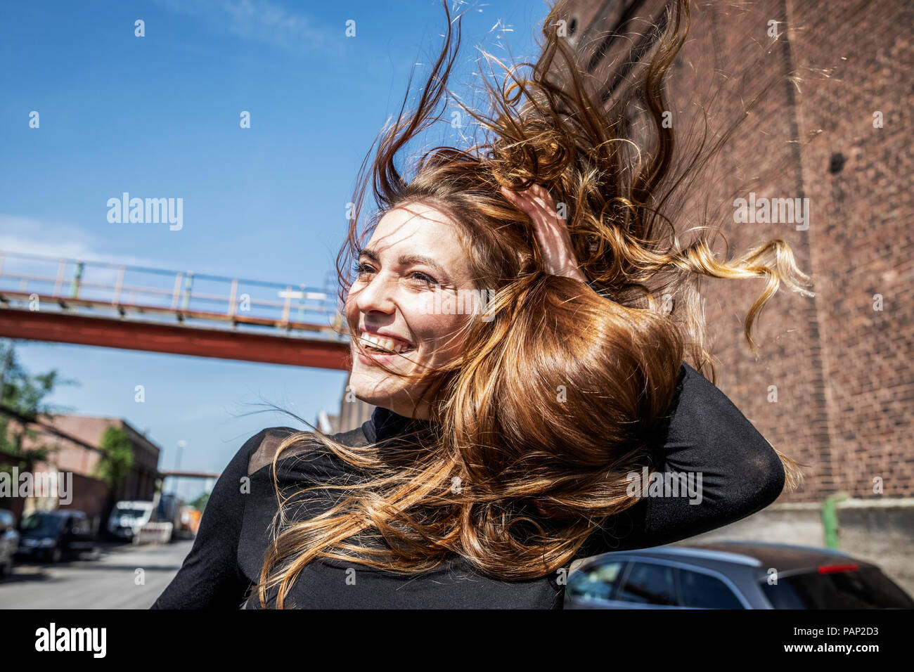 Portrait of laughing woman with blowing hair Stock Photo