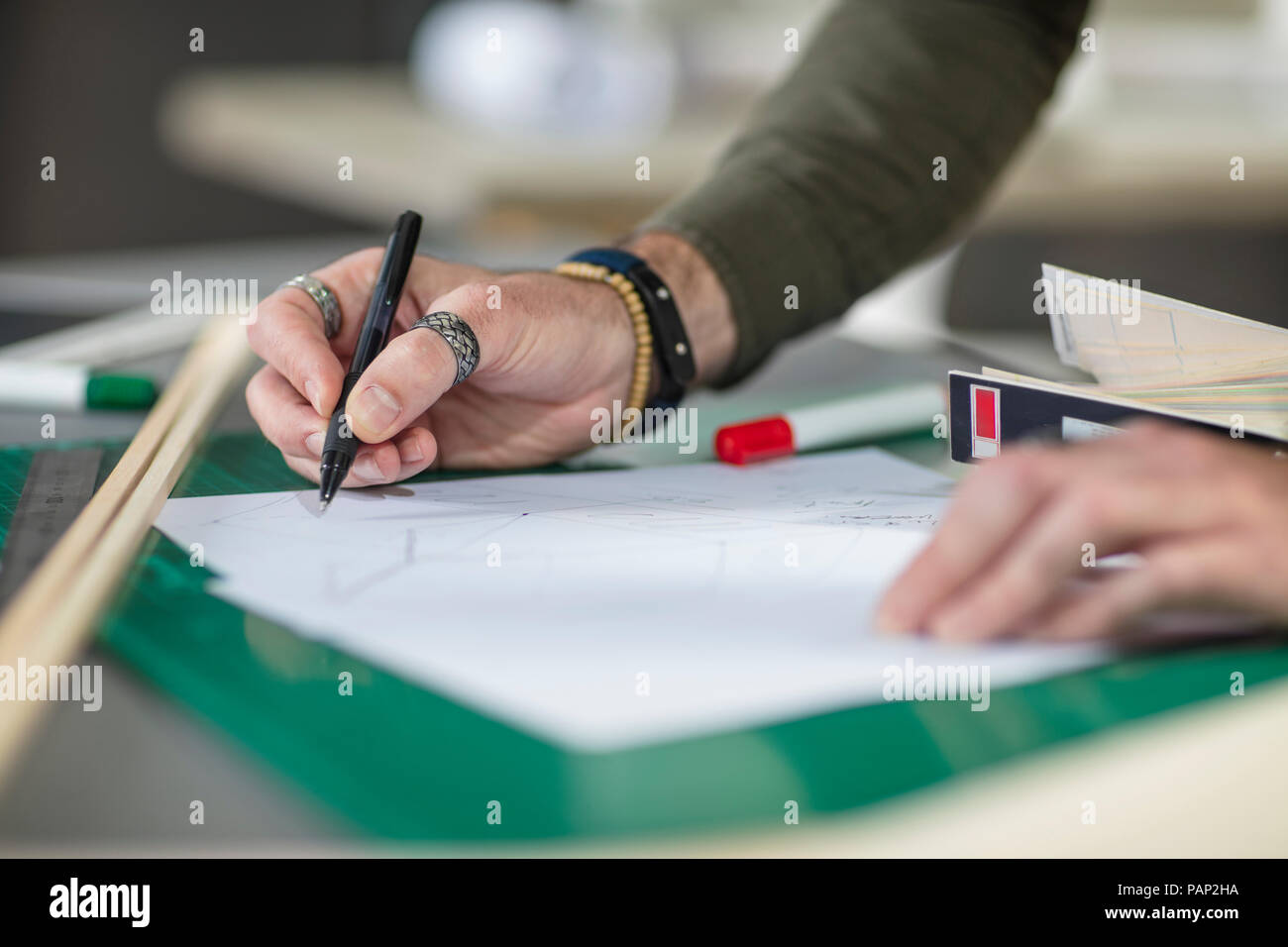 Close-up of man drawing at desk in office Stock Photo