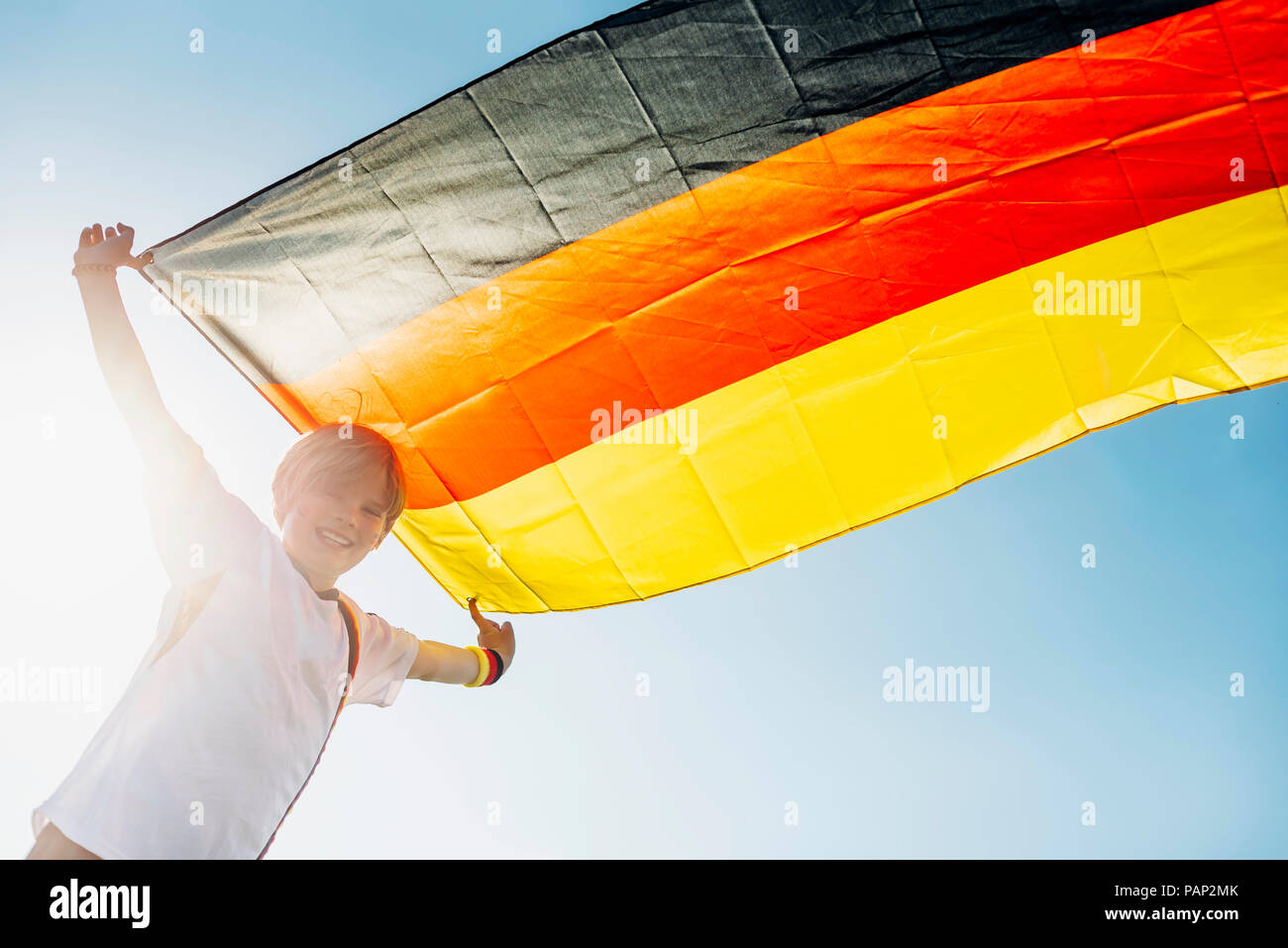 Boy, enthusiastic for soccer world championship, waving German flag Stock Photo