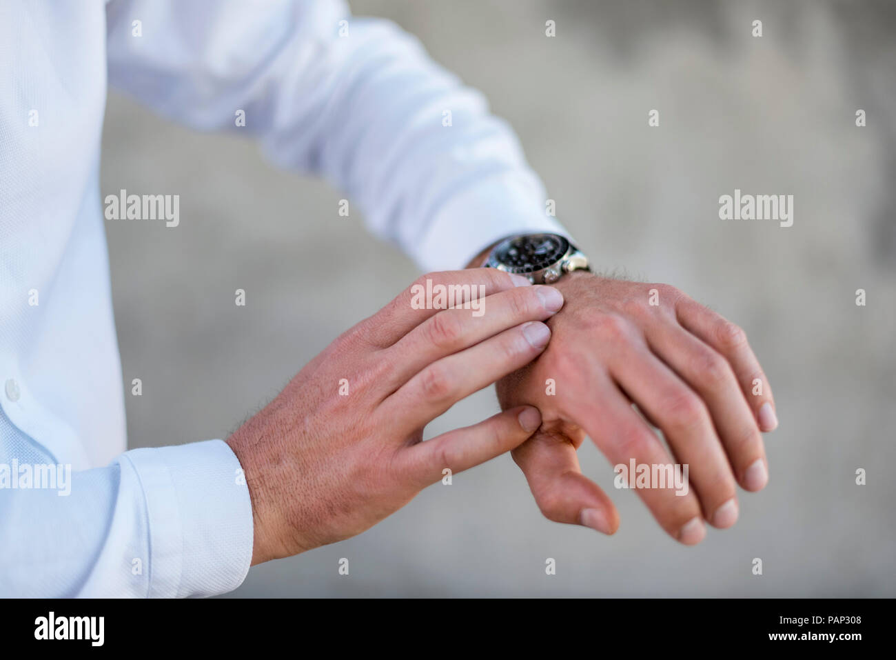 Close-up of businessman checking the time Stock Photo