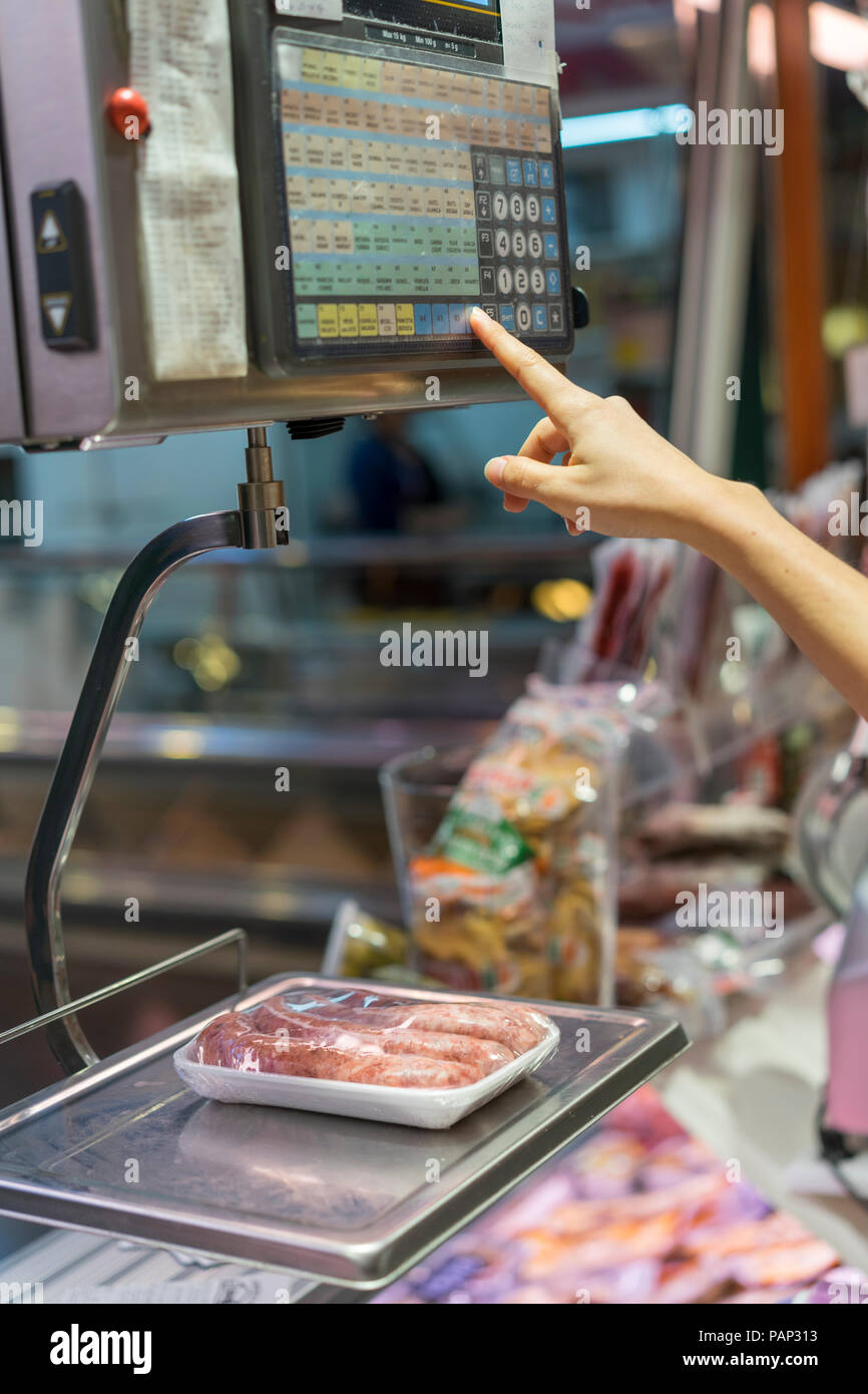 https://c8.alamy.com/comp/PAP313/female-butcher-weighing-sausage-on-scale-PAP313.jpg