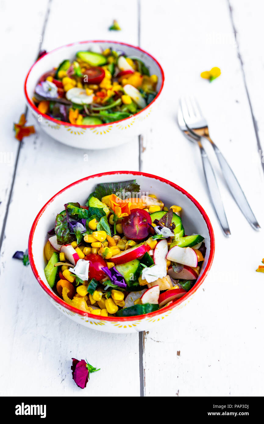 Bowls of mixed salad with edible flowers Stock Photo Alamy