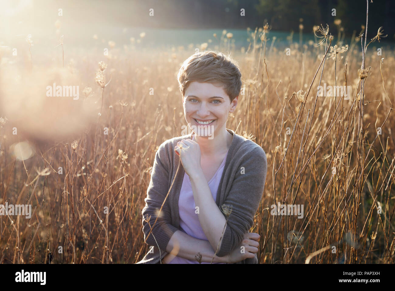 Portrait of smiling woman relaxing in nature Stock Photo