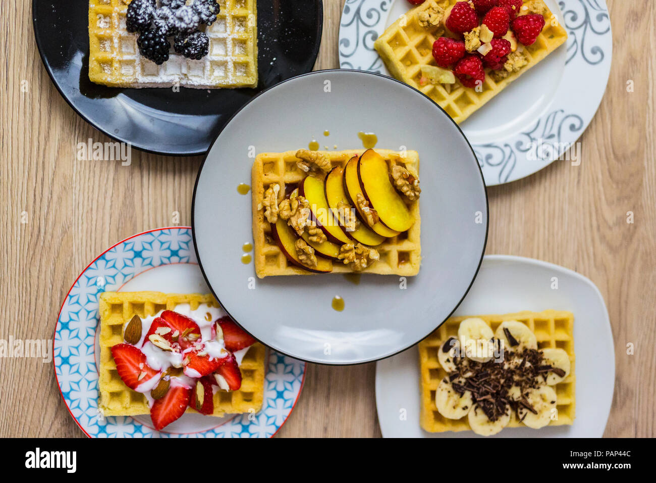 Plates of waffles with various toppings Stock Photo Alamy