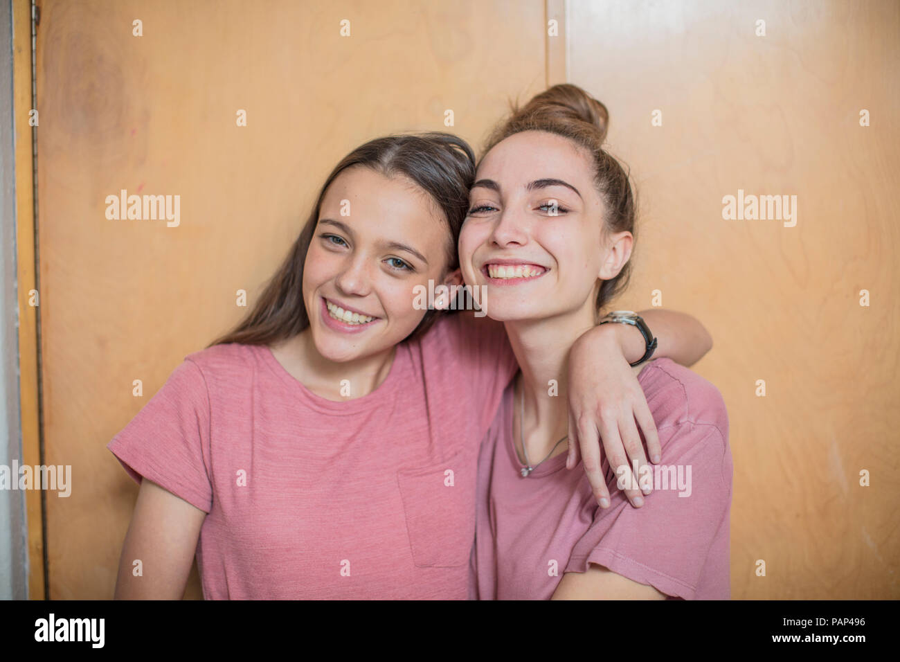 Portrait of two smiling teenage girls hugging Stock Photo