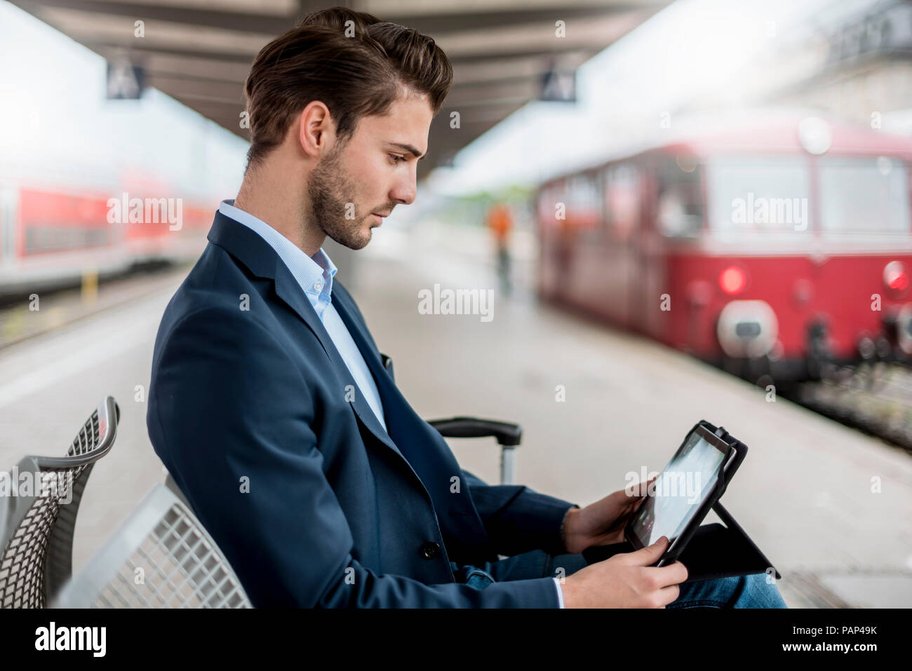 Businessman at the station using tablet Stock Photo