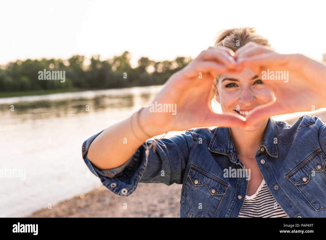 Woman making heart shape with hands and fingers Stock Photo
