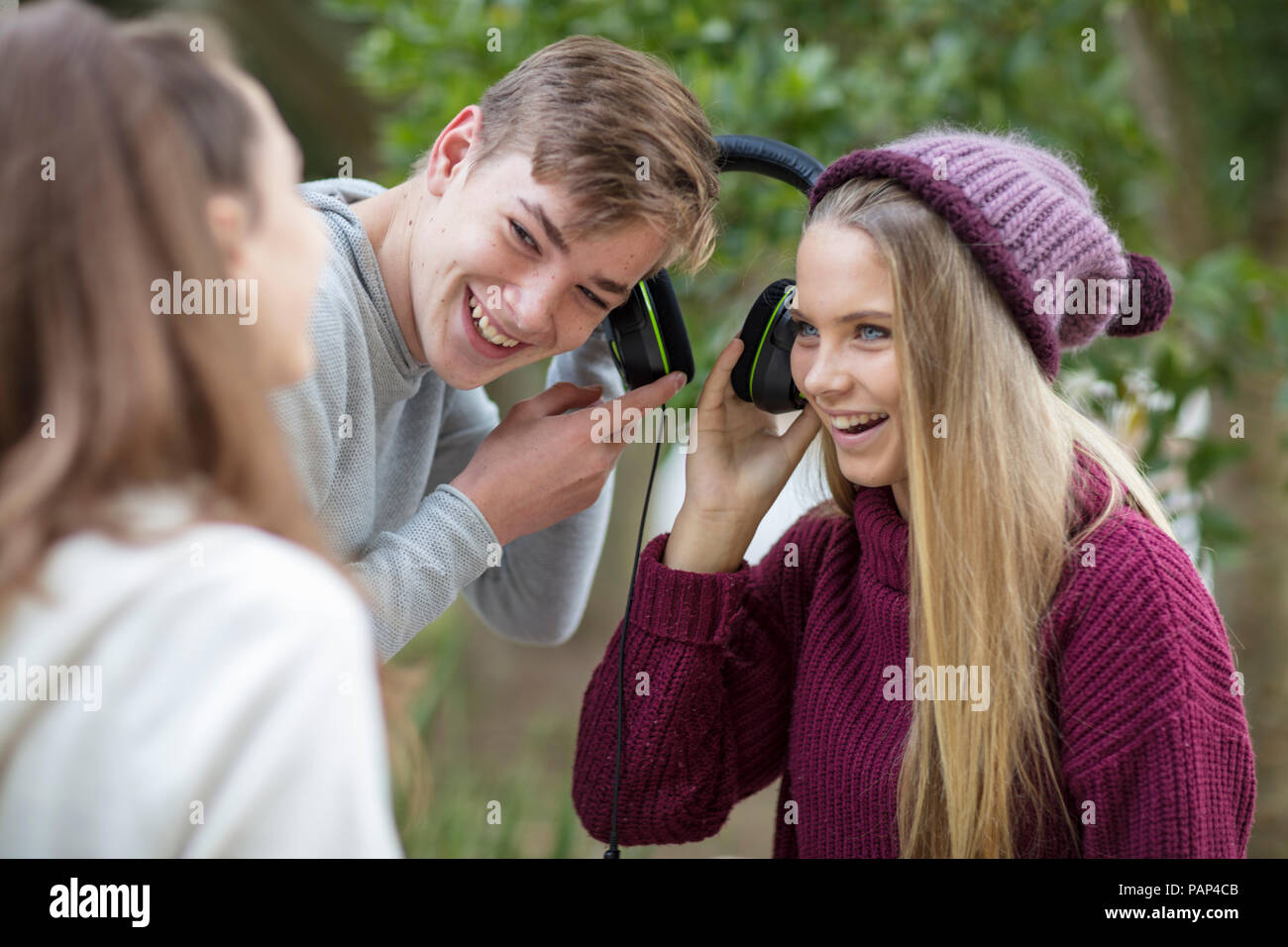 Happy friends listening to music from headphones Stock Photo