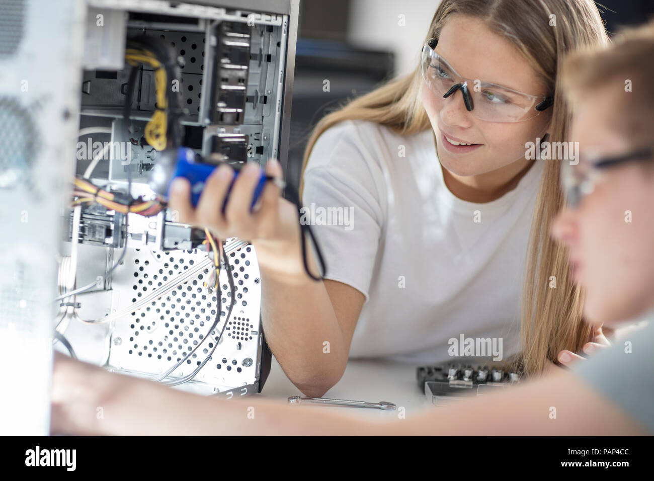 Students assembling computer in class Stock Photo